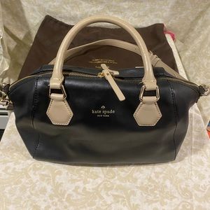 Kate Spade Satchel black with tan handles and strap.